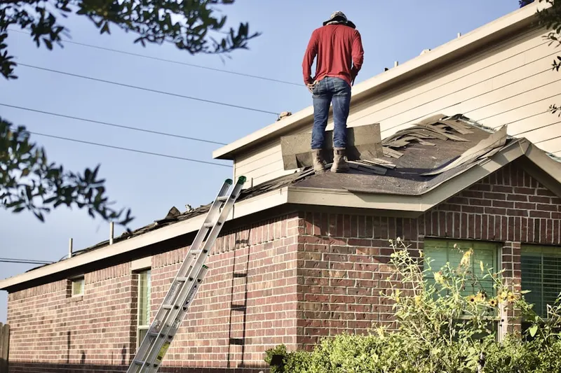 Professional roofer working on a residential roof in Beach Point